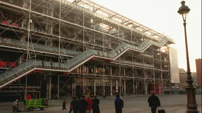 FILE - People walk in front of the Georges Pompidou Center in Paris on Jan. 28, 1997. Richard Rogers, the lauded British architect who was one of the forces behind the Pompidou Center in Paris and later designed London's Millennium Dome has died. He was 88. Rogers Stirk Harbour + Partners, the company he founded, confirmed his death in a statement Sunday Dec. 19, 2021. (AP Photo/Remy de la Mauviniere, File)