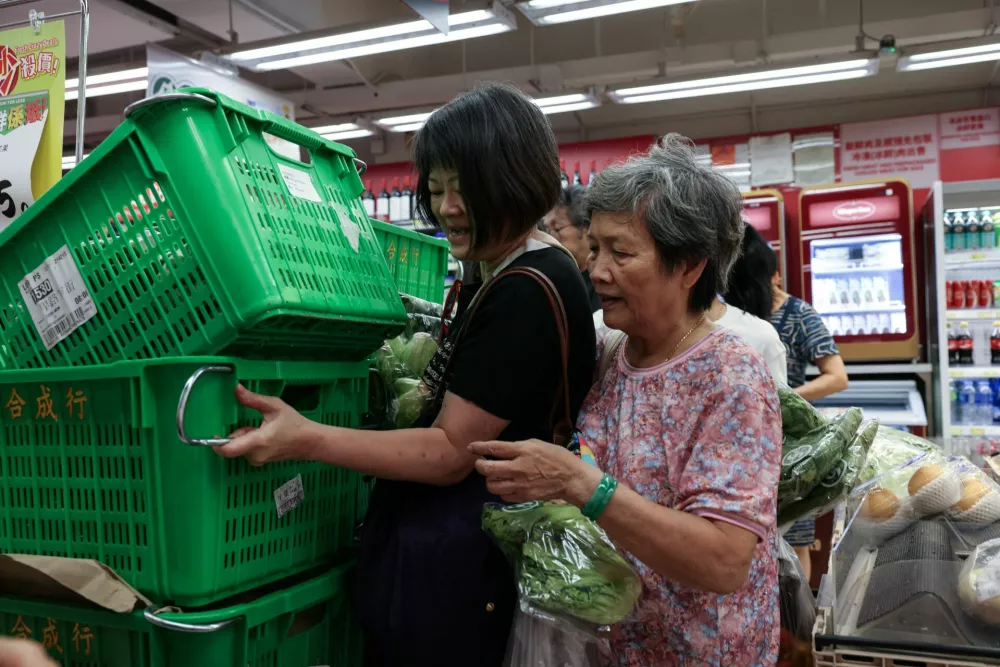 Residents stock up on supplies at a supermarket to prepare for the approaching Typhoon Ragasa, in Hong Kong, China, September 22, 2025. REUTERS/Tyrone Siu