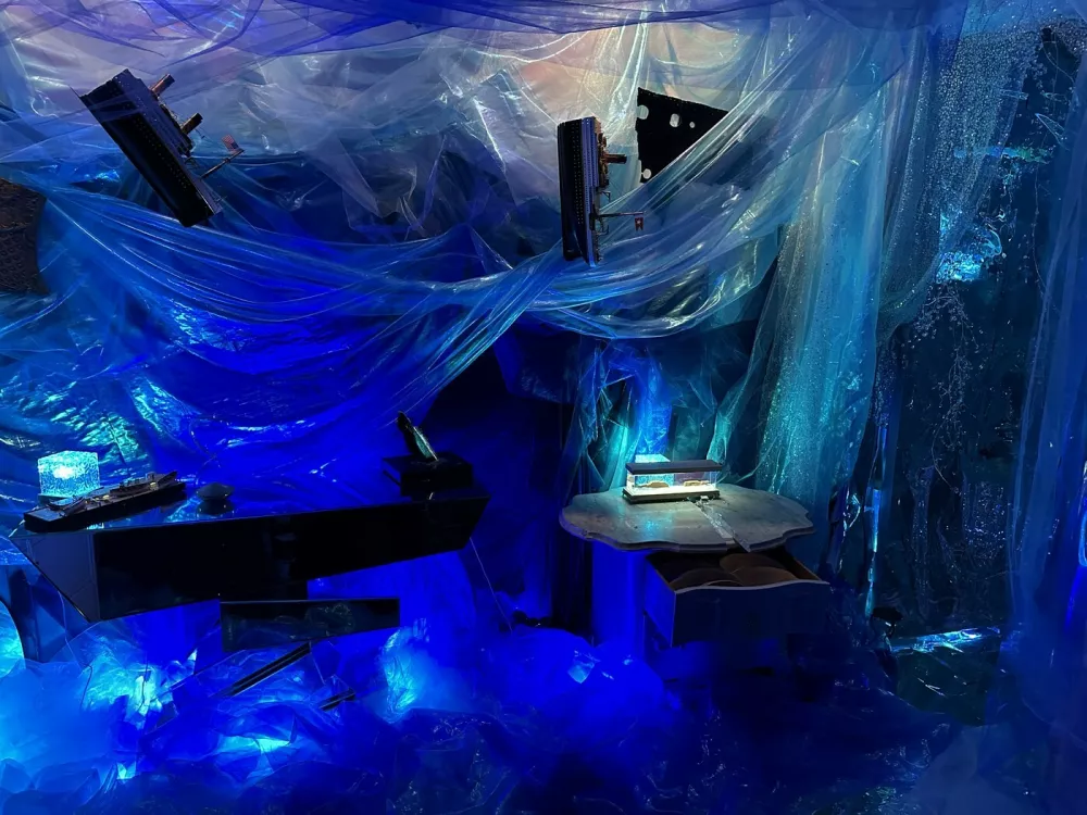 Story from Jam Press (Titanic Decorated Apartment)Pictured: Inside the Titanic home.Woman who has seen Titanic hundreds of times turns FLAT into ship replica with iceberg &ndash; and invites HINGE date overA woman has turned her flat into the TITANIC complete with a grand staircase and an iceberg &ndash; and she even invited her Hinge date round for a tour.Superfan Sarah Boll has spent months transforming her two-bed rental into a full-blown tribute to the doomed liner &ndash; and she's gone full steam ahead.The 27-year-old says what started as an idea for a small themed party quickly spiralled into an obsession.Now her walls, ceilings and even her bedroom have been revamped to recreate the ship's most famous rooms.From portholes to a "sinking room" and replica artefacts, every room has been styled to make you feel like you're stepping back into 1912."I've been a huge Titanic fanatic, to say the least, since I was 11," the model and a real estate agent told What's The Jam."For my high school graduation, my dad gave me a model ship of the Titanic, and my mom shipped it to me when I had space for it."I was going to have a small Titanic party, but once I started decorating, it was difficult to stop &ndash; especially after I started posting videos on TikTok.'Also, I just love interior design and anything to do with shades of blue and water."Sarah started decorating her New York City apartment in March 2025.Step inside and you're greeted by her version of the Grand Staircase, built with stick-on tiles, plastic ceiling panels and even a salad bowl turned into the glass dome.There are velvet ribbon walls, gold trim, faux greenery and mirrors dressed up as caf&eacute; windows.Sarah says her friends and family have been stunned by the transformation &ndash; but none more so than her Hinge date, who got the full Titanic tour when he came over to visit.She said: "He was totally on board. I told him about my apartment before he came over and asked if he would be okay if I filmed his reaction. He was so chill about it."The reactions from everyone else have been hilarious. Some people like it and others think it's insane."It's been 50/50 &ndash; there's been a lot of, 'I can't decide if she's cool or needs to be institutionalised'"Sarah says the real showstopper is her "sinking room", where visitors can first see Titanic sailing on a starry night before it hits the iceberg.Walking into the room, a model ship dangles from the ceiling mid-sink while a dresser painted to look like the liner appears to go down beneath the waves.The floor shimmers with mirrored silver paper like water, fabric drapes create the feel of being underwater and mini replicas show the wreck on the seabed.Sarah has even filled drawers with sand and crockery to echo what divers found.The bathroom continues the theme, covered in mirrored paper and newspaper clippings, with all 1,500 victims' names written out and stuck on the walls.Meanwhile, her bedroom has been styled as a first-class suite, complete with a gold comforter and a porthole by the bed.Sarah admits the whole thing came together impulsively &ndash; with no real plan &ndash; and she hasn't even kept track of how much it cost.She's since built a following of 18,000 online by sharing TikTok tours of her ship-shaped flat, with viewers torn between calling her a genius or saying she's lost the plot.And while Sarah says she may eventually change her apartment theme, for now she's staying firmly on board the Titanic &ndash; enjoying what she calls the best summer of her life.She said: "I'll switch up the theme eventually; I'm planning on an Alice in Wonderland theme."I'm not sure when I'll do that though. I want my parents to see Titanic first."I love my apartment &ndash; I've never had a better summer in my life."ENDSEDITOR'S NOTE: Video Usage Licence: (EXCLUSIVE) We have obtained an exclusive licence from the copyright holder. A copy of the licence is available on request.Video Restrictions: None.,Image: 1035233100, License: Rights-managed, Restrictions: EDITOR'S NOTE: Video Usage Licence: (EXCLUSIVE) We have obtained an exclusive licence from the copyright holder. A copy of the licence is available on request.Video Restrictions: None., Model Release: no