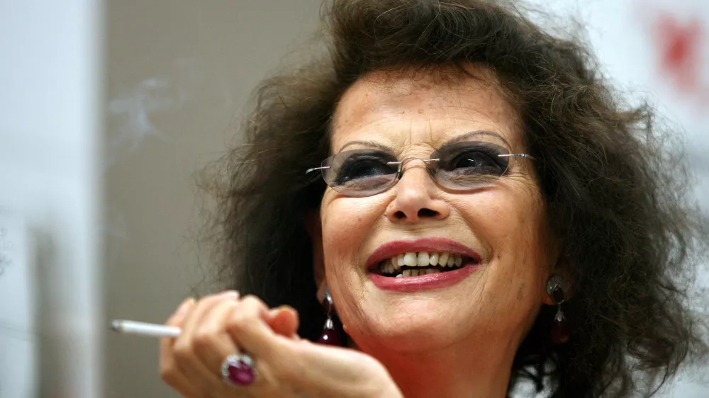 FILE PHOTO: Italian actress Claudia Cardinale smiles during a news conference in Cluj Napoca June 7, 2009. Cardinale received a lifetime award at the end of the eighth edition of the Transylvania International Film Festival (TIFF). REUTERS/Mircea Rosca (ROMANIA ENTERTAINMENT HEADSHOT)/File Photo