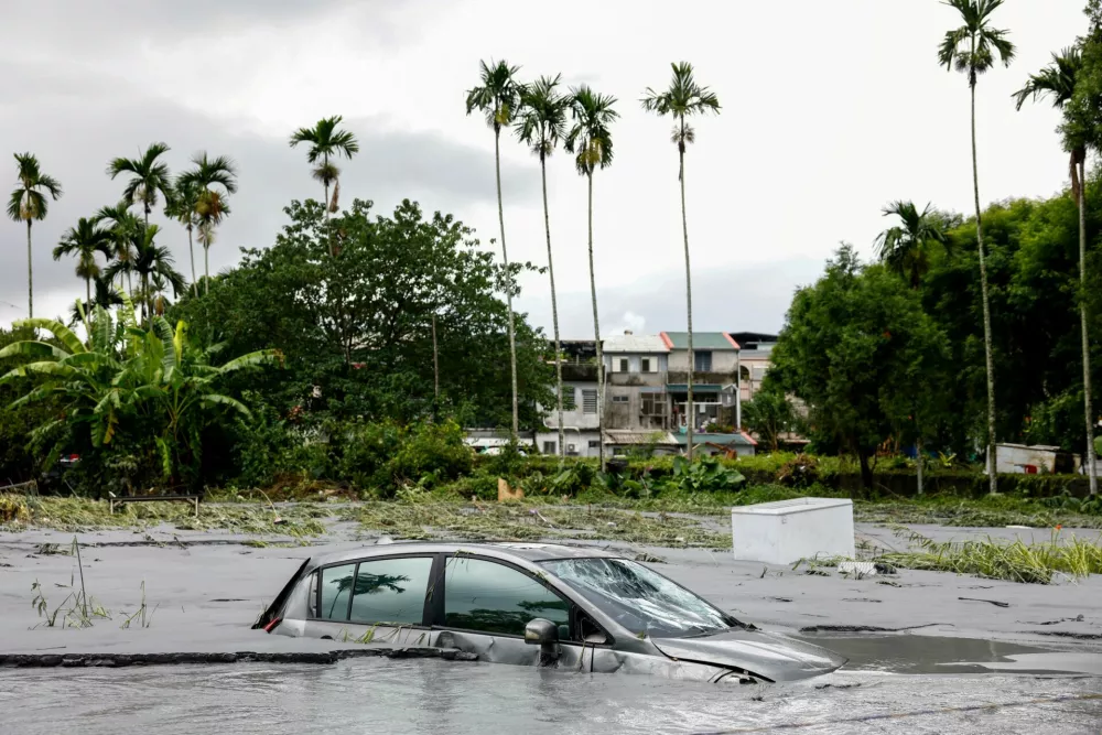 A car is partially submerged following flooding brought by Super Typhoon Ragasa in Hualien, Taiwan, September 24, 2025. REUTERS/Ann Wang
