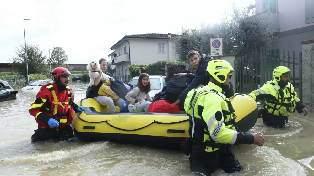 People are rescued by emergency services after heavy rainfall, in Tuscany, Italy, Saturday, Nov. 4, 2023. Record-breaking rain provoked floods in a vast swath of Tuscany as storm Ciar&aacute;n pushed into Italy overnight. At least six people were killed in that central Italian region. (Adriano Conte/LaPresse via AP)