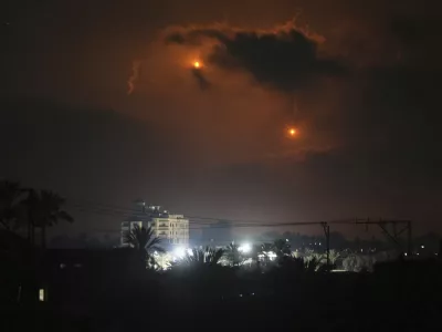 Illumination flares launched by the Israeli army are seen over Deir al-Balah in central Gaza Strip Monday, July 21, 2025. (AP Photo/Abdel Kareem Hana)