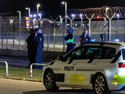 FILE PHOTO: Police officers stand guard after all traffic has been closed at the Copenhagen Airport due to drone reports in Copenhagen, Denmark September 22, 2025. Ritzau Scanpix/Steven Knap via REUTERS  ATTENTION EDITORS - THIS IMAGE WAS PROVIDED BY A THIRD PARTY. DENMARK OUT. NO COMMERCIAL OR EDITORIAL SALES IN DENMARK./File Photo