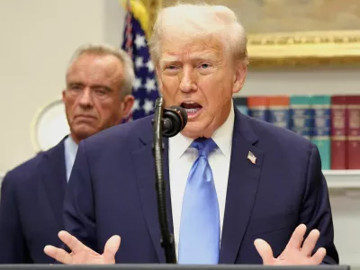 FILE PHOTO: U.S. President Donald Trump, in front of U.S. Secretary of Health and Human Services Robert F. Kennedy Jr., delivers remarks linking autism to childhood vaccines and to the use of popular pain medication Tylenol for pregnant women and children, claims which are not backed by decades of science, at the White House in Washington, D.C., U.S., September 22, 2025. REUTERS/Kevin Lamarque/File Photo