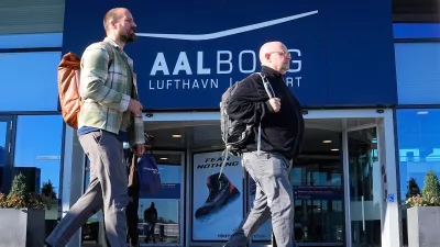 Passengers walk past one of the entrances of Aalborg Airport, in Denmark, Thursday, Sept. 25, 2025, after drones were observed on the airport on Wednesday evening and the night to Thursday, and the airspace over the airport was closed. (Bo Amstrup/Ritzau Scanpix via AP)