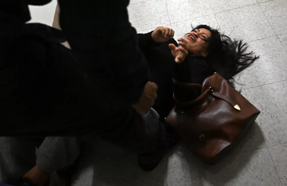 25 September 2025, US, New York: A woman is tackled to the ground by an officer at the Jacob Javits Federal Building in New York. Photo: Carol Guzy/ZUMA Press Wire/dpa
