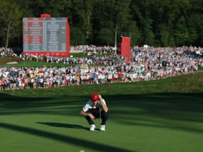 Golf - The 2025 Ryder Cup - Bethpage Black Golf Course, Farmingdale, New York, United States - September 28, 2025 Team USA's Russell Henley lines up his putt on the 17th hole during the singles REUTERS/Paul Childs
