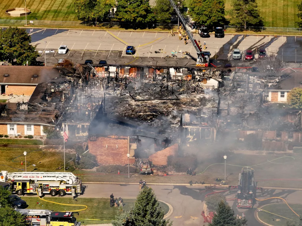 Emergency crews respond to a shooting and fire at The Church of Jesus Christ of Latter-day Saints, in Grand Blanc, Mich., Sept. 28, 2025. (David Guralnick/Detroit News via AP)