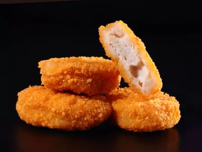 A pile of chicken nuggets isolated on black color background