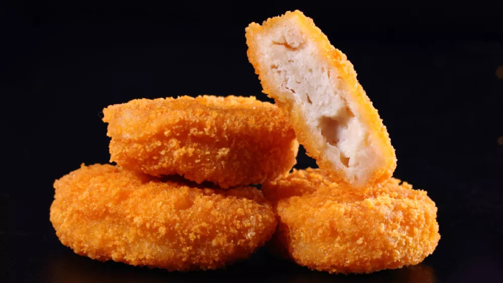 A pile of chicken nuggets isolated on black color background