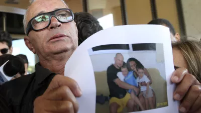 Nelson Marinho holds a photo of his son Nelson Marinho, seen with his family, a passenger on Air France flight 447 that was reported missing on its way from Rio de Janeiro to Paris, at the Windsor hotel in Rio de Janeiro, Wednesday, June 3, 2009. Brazil's military found a 3-mile (5-kilometer) path of wreckage in the Atlantic Ocean, confirming that the jet carrying 228 people crashed in the sea, according to Defense Minister Nelson Jobim. (AP Photo/Patricia Santos)