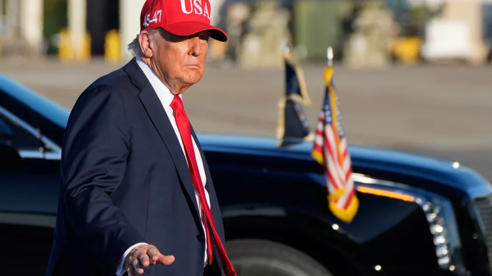 President Donald Trump walks to board Air Force One at Naval Station Norfolk Chambers Field in Norfolk, Va., Sunday, Oct. 5, 2025. (AP Photo/Alex Brandon)