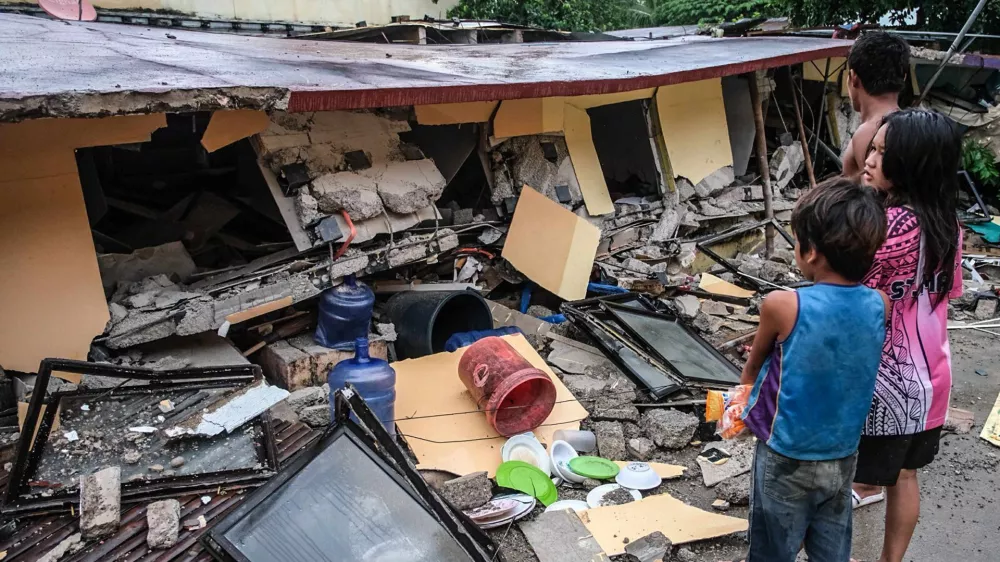 People look at a collapsed building in Bogo City, Cebu province, Philippines Wednesday, Oct. 1, 2025 after an offshore earthquake on late Tuesday. (AP Photo)