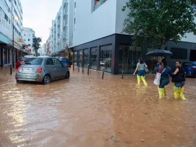 30 September 2025, Spain, Ibiza: People walk along a flooded street in the Balearic city of Ibiza after a heavy rainfall. Photo: Germ&aacute;n Lama/EUROPA PRESS/dpa