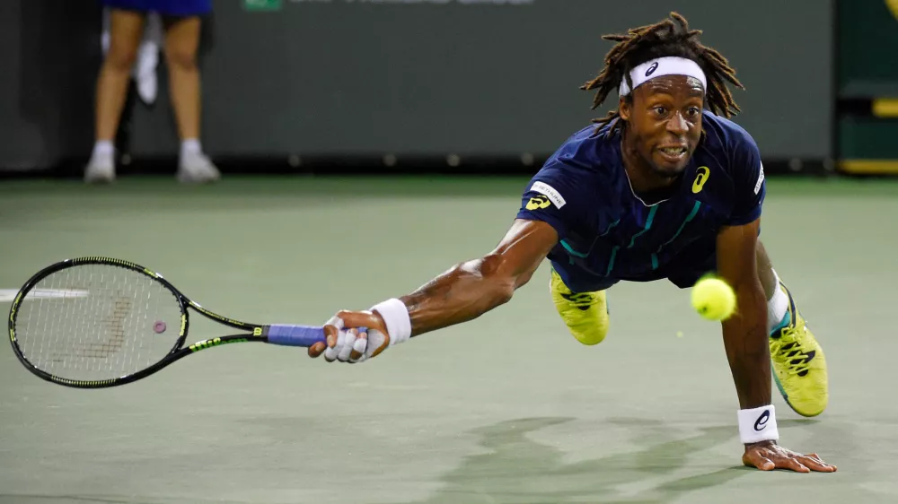 FILE - Gael Monfils, of France, dives as he returns a shot to Milos Raonic, of Canada, at the BNP Paribas Open tennis tournament, Thursday, March 17, 2016, in Indian Wells, Calif. Raonic won 7-5, 6-3. (AP Photo/Mark J. Terrill, File)
