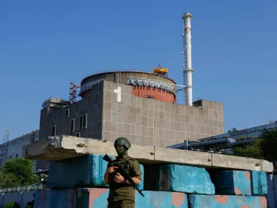FILE PHOTO: A Russian service member stands guard at a checkpoint near the Zaporizhzhia Nuclear Power Plant before the arrival of the International Atomic Energy Agency (IAEA) expert mission in the course of Russia-Ukraine conflict outside Enerhodar in the Zaporizhzhia region, Russian-controlled Ukraine, June 15, 2023. REUTERS/Alexander Ermochenko/File Photo