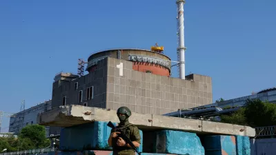 FILE PHOTO: A Russian service member stands guard at a checkpoint near the Zaporizhzhia Nuclear Power Plant before the arrival of the International Atomic Energy Agency (IAEA) expert mission in the course of Russia-Ukraine conflict outside Enerhodar in the Zaporizhzhia region, Russian-controlled Ukraine, June 15, 2023. REUTERS/Alexander Ermochenko/File Photo