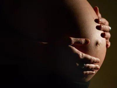 FILED - 08 January 2007, North Rhine-Westphalia, Bonn: A heavily pregnant woman clutches her stomach with both hands. Three doctors in Poland have been convicted over the death of a woman who died from pregnancy complications after they refrained from performing an abortion that could have saved her life. Photo: Felix Heyder/dpa