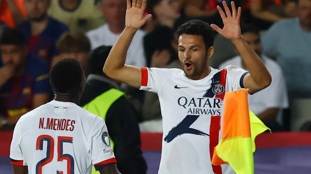 Soccer Football - UEFA Champions League - FC Barcelona v Paris St Germain - Estadi Olimpic Lluis Companys, Barcelona, Spain - October 1, 2025 Paris St Germain's Goncalo Ramos celebrates scoring their second goal with Nuno Mendes REUTERS/Albert Gea