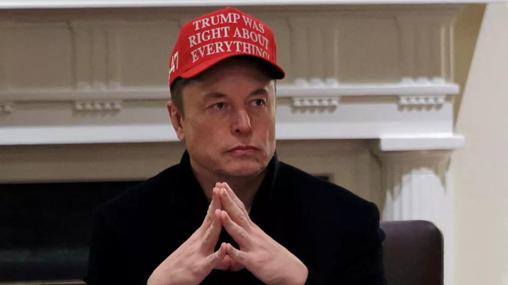 FILE PHOTO: Tesla CEO Elon Musk wears a 'Trump Was Right About Everything!' hat while attending a cabinet meeting at the White House, in Washington, D.C., U.S., March 24, 2025. REUTERS/Carlos Barria/File Photo