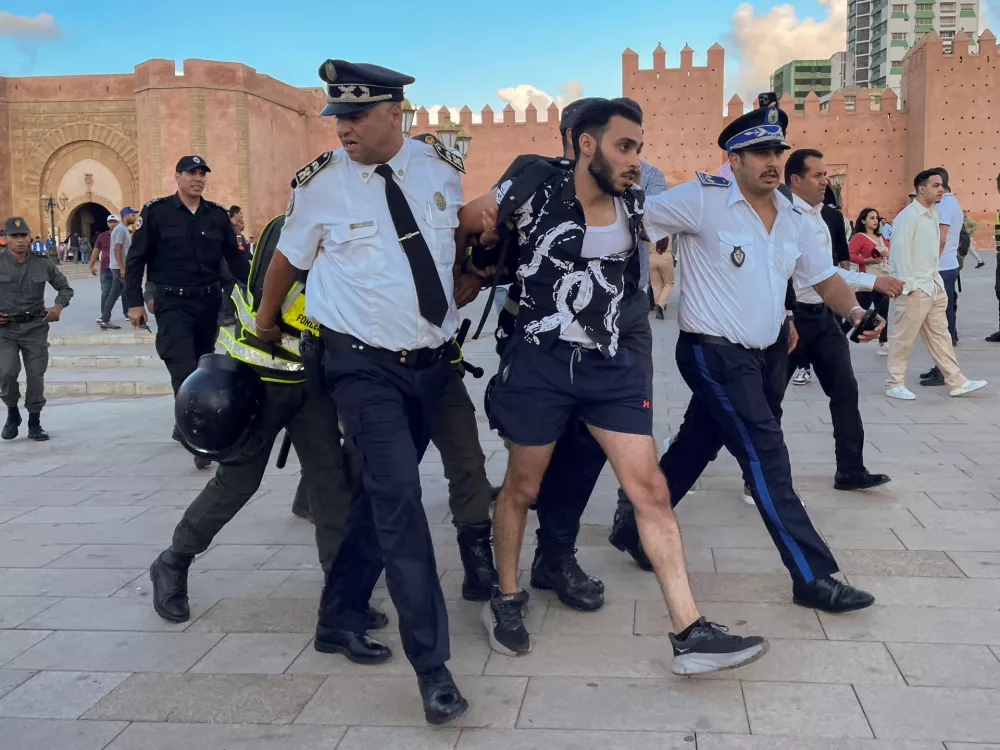 Members of the security forces detain a man as they prevent a protest demanding reforms in education and health from taking place, in Rabat, Morocco, September 29, 2025. REUTERS/Ahmed El Jechtimi