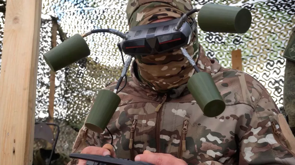 In this photo taken from video distributed by Russian Defense Ministry Press Service on Tuesday, Sept. 30, 2025, A Russian soldier controls a drone for an action in an undisclosed location in Ukraine. (Russian Defense Ministry Press Service via AP)