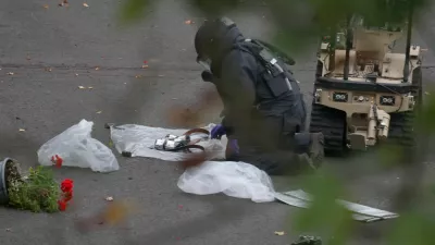 A bomb disposal technician secures evidence at the scene, after a report of an incident in which a car was driven at pedestrians and a stabbing attack outside a synagogue, in north Manchester, Britain, October 2, 2025. REUTERS/Hannah McKay