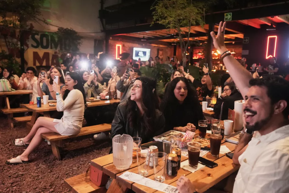 Fans gather to celebrate the release of Taylor Swift's new album, "The Life of a Showgirl" in Mexico City, Thursday, Oct. 2, 2025. (AP Photo/Claudia Rosel)