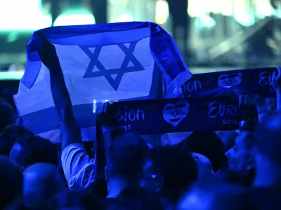 17 May 2025, Switzerland, Basel: A person holds an Israeli flag during the Grand Final of the Eurovision Song Contest 2025 in Basel. The European Broadcasting Union (EBU), which organizes Eurovision, said on Thursday that it will hold an online meeting in November to vote on participation in the 2026 contest, as debate over Israel's involvement continues to stir controversy. Photo: Heikki Saukkomaa/Lehtikuva/dpa
