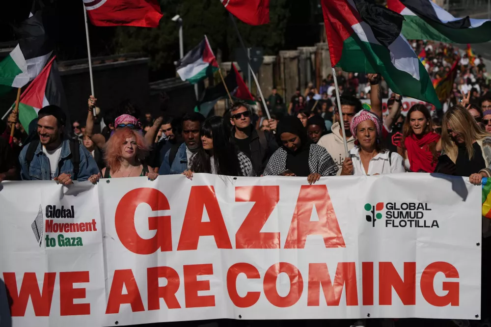 Pro-Palestinian demonstrators march along the Rome's ring road as they gather for a national general strike called by different unions to protest against the situation in Gaza two days after Israeli forces intercepted a Gaza-bound aid flotilla in the Mediterranean Sea, in Rome, Friday, Oct. 3, 2025. (AP Photo/Alessandra Tarantino)
