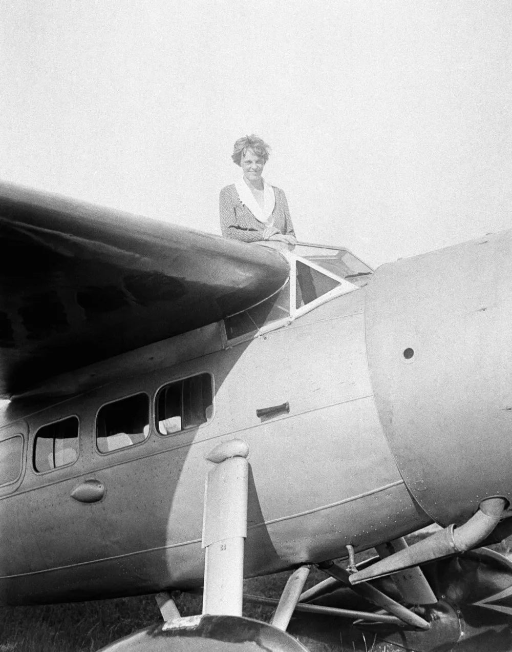 FILE - In this undated photo, Amelia Earhart, the first woman to cross the Atlantic Ocean by plane sits on top of a plane. Secretary of State Hillary Rodham Clinton is wading into one of the 20th century's most enduring mysteries: the fate of American aviator Amelia Earhart, disappeared over the South Pacific 75 years ago. Clinton is meeting March 20, 2012, with historians and scientists from The International Group for Historic Aircraft Recovery, which will launch a new search in June for the wreckage of Earhart's plane off the remote island of Nikumaroro. (AP Photo)