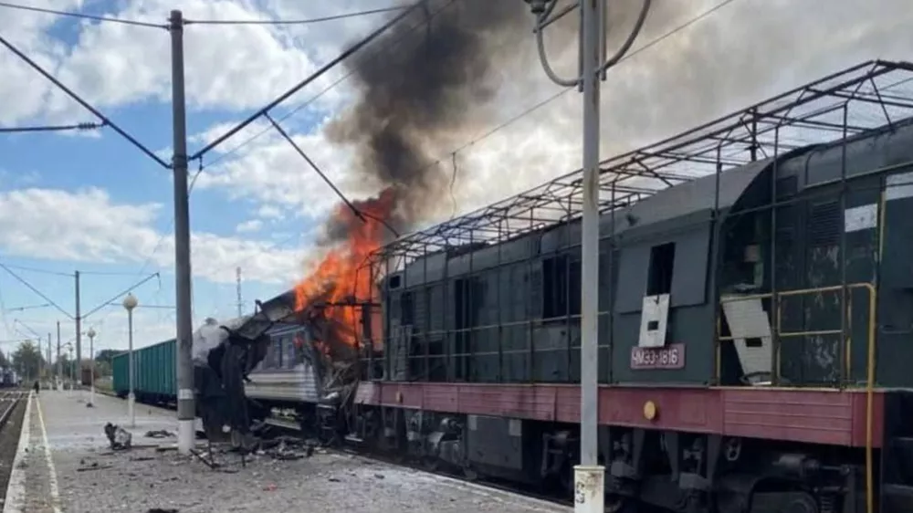 In this photo provided by the Ukrainian Railway press office, a passenger train is engulfed in flames following Russia's drone attack on a railway station in Shostka, Sumy region, Ukraine, Saturday, Oct. 4, 2025. (Ukrainian Railway via AP)