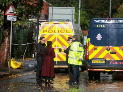 Britain's Conservative Party leader Kemi Badenoch stands with Mayor of Greater Manchester Andy Burnham and Assistant Chief Constable John Webster, as she makes a visit to the site near the Manchester synagogue, where multiple people were killed on Yom Kippur, in what police have declared a terrorist incident, in north Manchester, Britain, October 4, 2025. REUTERS/Temilade Adelaja