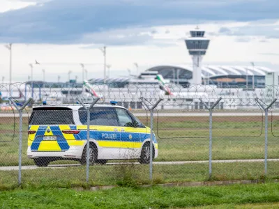 04 October 2025, Bavaria, Munich: A police vehicle drives on the grounds of Munich Airport. After sightings of drones, flight operations were resumed on Saturday morning. Photo: Armin Weigel/dpa