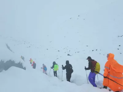 A screen capture from video shows trekkers leaving their campsite, as unusually heavy snow and rainfall pummeled the Himalayas, in the Tibet Region, China, October 5, 2025. Geshuang Chen/Handout via REUTERS. THIS IMAGE HAS BEEN SUPPLIED BY A THIRD PARTY NO RESALES. NO ARCHIVES. MANDATORY CREDIT