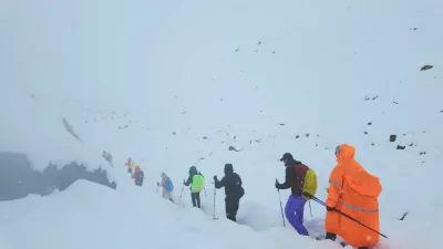 A screen capture from video shows trekkers leaving their campsite, as unusually heavy snow and rainfall pummeled the Himalayas, in the Tibet Region, China, October 5, 2025. Geshuang Chen/Handout via REUTERS. THIS IMAGE HAS BEEN SUPPLIED BY A THIRD PARTY NO RESALES. NO ARCHIVES. MANDATORY CREDIT