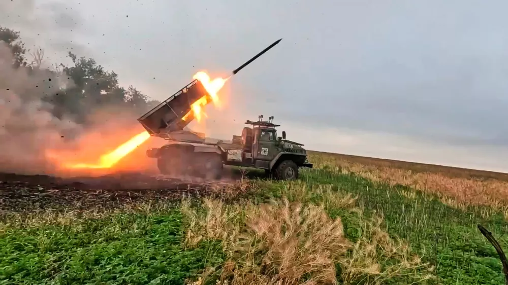 In this photo taken from video distributed by Russian Defense Ministry Press Service on Monday, Oct. 6, 2025, a Russian "Grad" self-propelled 122 mm multiple rocket launcher fires towards Ukrainian positions on an undisclosed location in Ukraine. (Russian Defense Ministry Press Service via AP)