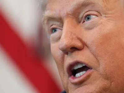 President Donald Trump speaks to reporters before signing an executive order in the Oval Office at the White House, Monday, Oct. 6, 2025, in Washington. (AP Photo/Jacquelyn Martin)