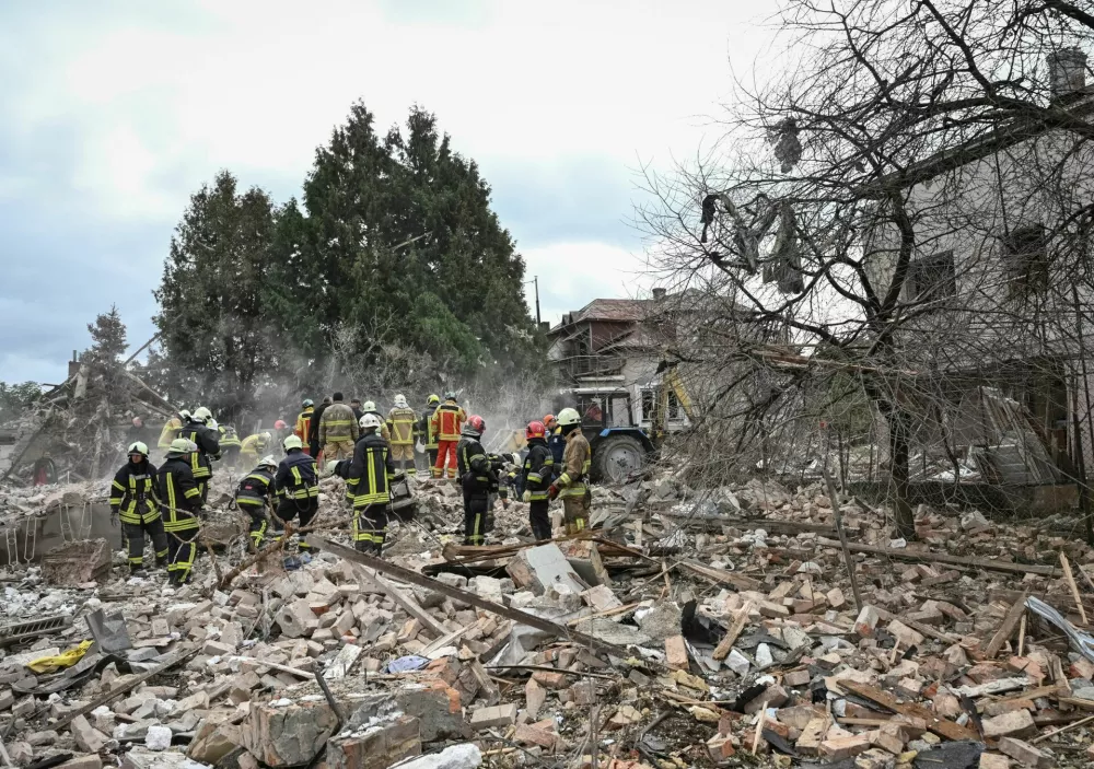 Rescuers work at the site of a house destroyed during a Russian drone and missile strike, amid Russia's attack on Ukraine, in the village of Lapaivka on the outskirts of Lviv, Ukraine October 5, 2025. REUTERS/Stringer