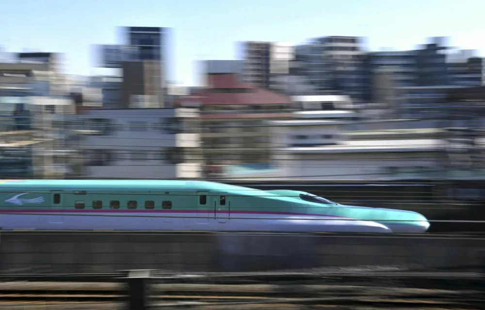 "Hayabusa'' a new shinkansen train makes its debuting operation on the Tohoku Shinkansen Line on Saturday, in Arakawa Ward in Tokyo, March 5, 2011. East Japan Railway, Co. launched the thin-nosed green bullet train, operating 300 kilometer per hour to make a trip from Tokyo to Shin-Aomori, the 675 kilometer distance in three hours and 10 minutes. (The Yomiuri Shimbun via AP Images)