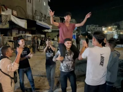 Palestinians celebrate on a street following the news that Israel and Hamas have agreed on Wednesday to the first phase of U.S. President Donald Trump's plan for Gaza, in Khan Younis in the southern Gaza Strip, in this screengrab obtained from a video released on October 9, 2025. Video Obtained by REUTERS THIS IMAGE HAS BEEN SUPPLIED BY A THIRD PARTY. NO RESALES. NO ARCHIVES.   TPX IMAGES OF THE DAY