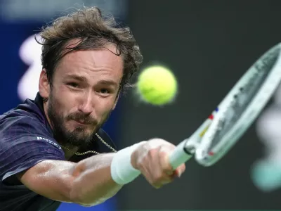Daniil Medvedev of Russia returns a backhand shot from Alex De Minaur of Australia during their men's singles quarterfinal match of the Shanghai Masters tennis tournament at Qizhong Forest Sports City Tennis Center, in Shanghai, China, Friday, Oct. 10, 2025. (AP Photo/Andy Wong)