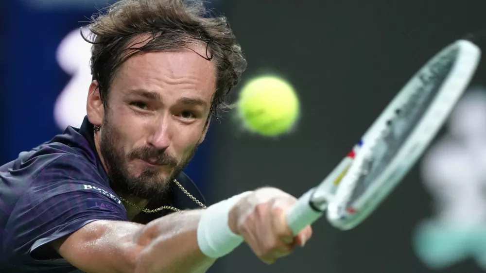 Daniil Medvedev of Russia returns a backhand shot from Alex De Minaur of Australia during their men's singles quarterfinal match of the Shanghai Masters tennis tournament at Qizhong Forest Sports City Tennis Center, in Shanghai, China, Friday, Oct. 10, 2025. (AP Photo/Andy Wong)