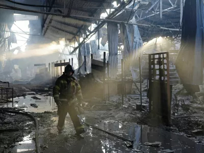 A firefighter works inside the burned-out Sigma shopping mall following yesterday evening's Ukrainian military strike, in the course of Ukraine-Russia conflict in Donetsk, a Russian-controlled city of Ukraine, October 12, 2025. REUTERS/Alexander Ermochenko