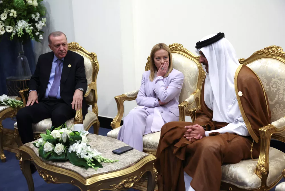 From left, Turkey's President Recep Tayyip Erdogan, Italy's Prime Minister Giorgia Meloni and Emir of Qatar Sheikh Tamim ibn Hamad Al Thani meet before attending a world leaders' summit on ending the Gaza war, in Sharm el-Sheikh, Egypt, Monday, Oct. 13, 2025. (Suzanne Plunkett, Pool Photo via AP)