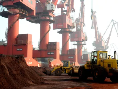 FILE PHOTO: Workers transport soil containing rare earth elements for export at a port in Lianyungang, Jiangsu province, China, October 31, 2010. REUTERS/Stringer ATTENTION EDITORS - THIS IMAGE WAS PROVIDED BY A THIRD PARTY. CHINA OUT./File Photo