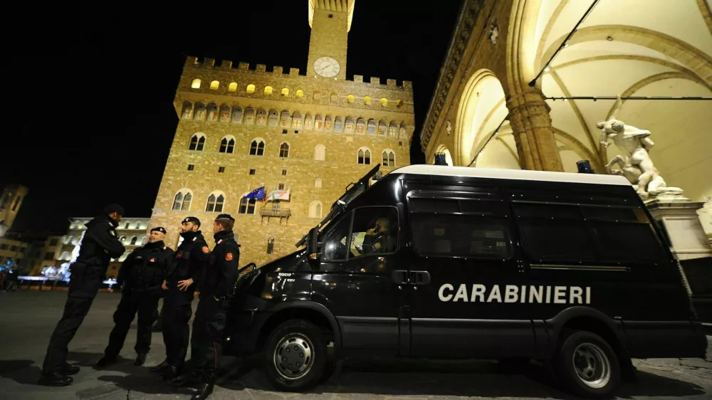 Florence, Italy - December 15 2021: The monuments of the historic center presided over by the Carabinieri: Palazzo Vecchio and the Loggia dei Lanzi in Piazza della Signoria.