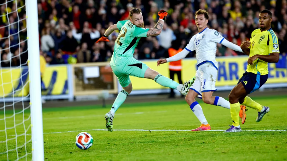 Kosovo's Fisnik Asllani scores the opening goal past Sweden's goalkeeper Viktor Johansson during the 2026 World Cup Group B qualifying soccer match between Sweden and Kosovo Monday Oct. 13, 2025 in Gothenburg, Sweden. (Adam Ihse/TT News Agency via AP)