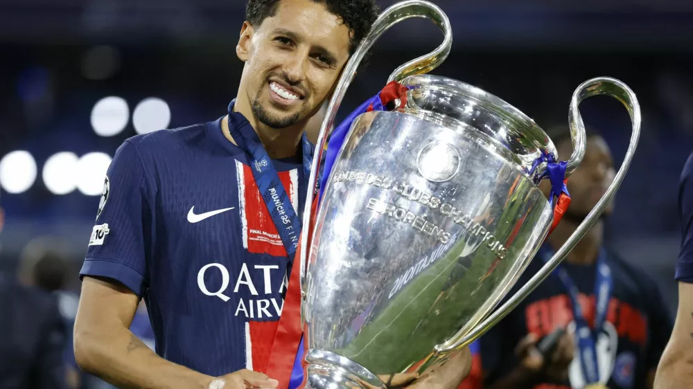 Soccer Football - Champions League - Final - Paris St Germain v Inter Milan - Allianz Arena, Munich, Germany - May 31, 2025 Paris St Germain's Marquinhos celebrates with the trophy after winning the Champions League REUTERS/Peter Cziborra
